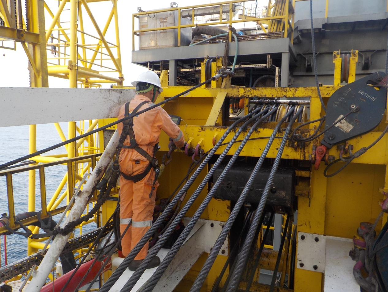 OPS-OES surveyor inspecting an offshore pedestal crane wire rope and sheave assembly